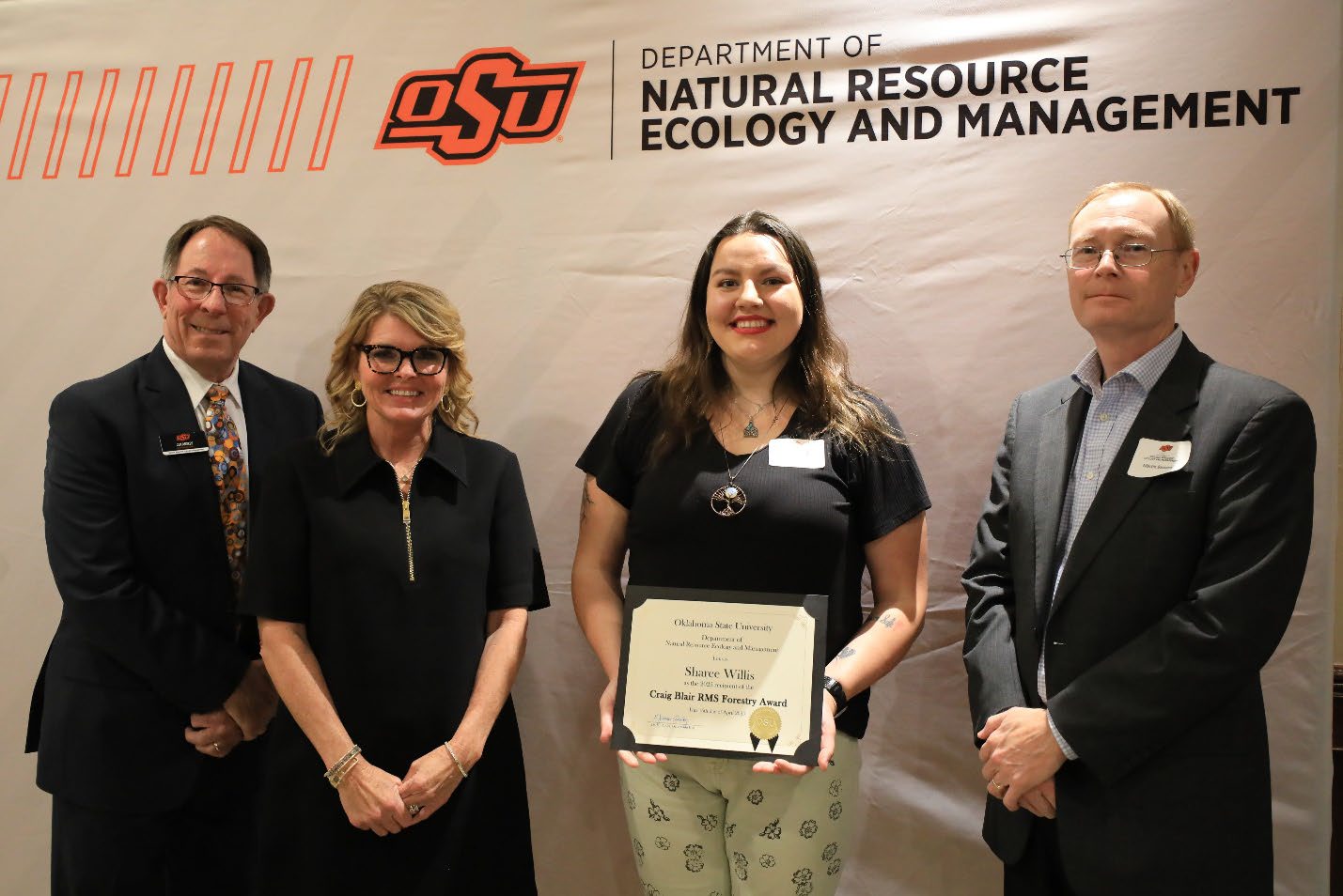 Sharee Willis with her scholarship plaque and Mary Kay Greer, Martin Beavers and Dr. Jim Ansley.