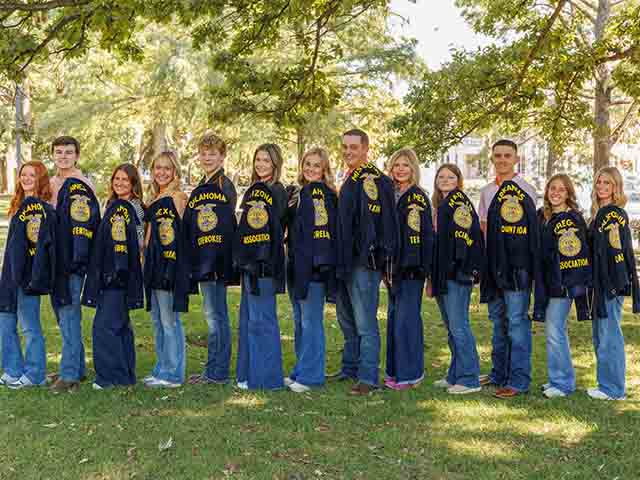 students holding FFA jackets over their shoulder