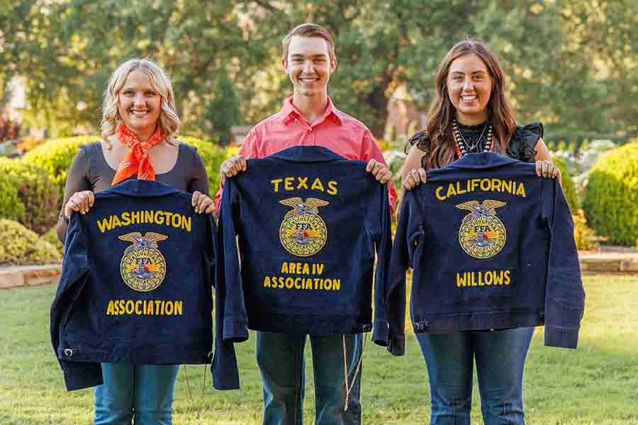 Three students holding FFA jackets.